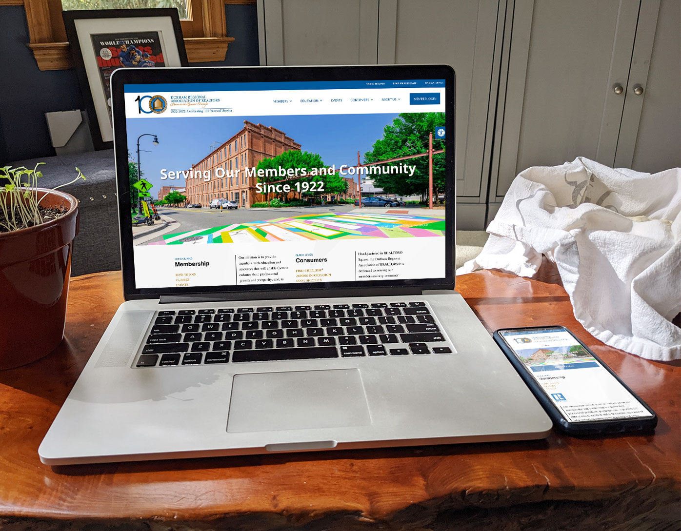 a laptop computer sitting on a wood table showing a realtor website